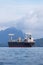 Large container cargo ship sailing in raining weather.