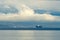 Large container ship sailing at sea in overcast morning close to the Rijeka town shoreline in Croatia