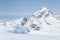 Large cornice of overhanging snow from Youngs Peak looking up at Mount Sir Donald