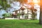 Large cottage in a pine forest clearing. Summer day