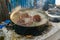 Large crabs being boiled in an iron pot in a rustic kitchen