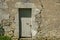 A large crack in the wall of a rustic outbuilding