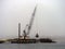 Large Crane Dredging the Winchester Bay in Oregon.