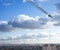 Large crane in sky above urban horizon