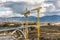 Large cranes in the construction of a bridge in a valley in Segovia Spain