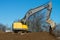 large crawler excavator pours a bunch of sand