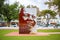 Large creative Nelson Mandela stone artwork standing in the center of green courtyard in Stellenbosch.