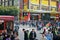 Large crowds of people moving past a McDonalds Store in China