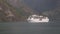 Large cruise ship entering a Norwegian fjord.