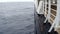 Large cruise ship at open sea. Waves splashing on the side of ship.