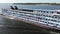 A large cruise ship with tourists on board runs along the Volga downstream towards Astrakhan. Volgograd.