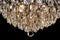 Large crystal chandelier detail isolated on black background.