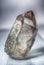 Large crystal of transparent quartz on light background close-up