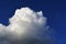 Large cumulus cloud in the dark blue sky