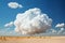 a large cumulus cloud over the desert, a beautiful landscape with blue sky as an abstract summer background