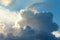 Large cumulus, nimbus clouds with silver lining, in blue, and white