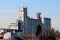 Large dilapidated industrial complex concrete storage silos with multiple cell phone antennas and transmitters on top