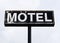 Large dilapidated and peeling motel sign