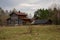 Large, dilapidated wooden house in a forest glade