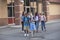 Large, diverse group of kids leaving school at the end of the day. School friends walking together and talking together on their w