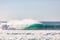 Large dramatic wave breaking hard over volcanic reef in hawaii