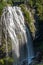 A large drop waterfall photographed on a long exposure to create blurred motion to the water, the Narada Waterfall