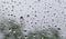 Large drops of water on the glass. Raindrops on the windshield of a car against the background of the sky