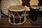 A large drum made of wood and leather,tied with twine. A small drum made of Buffalo leather and mahogany. National musical instrum