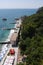 A large embankment with hulls for tourists, restaurants, children`s playgrounds and piers on the background of mountains