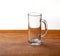 Large empty pint of beer on old wooden table