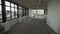 Large empty room with big black framed windows and white walls and ceiling.