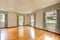 Large empty room with hardwood floor and curtains. Old luxury home.