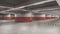 Large empty underground parking with red and white brickwall
