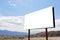 A large, empty, white advertising sign in the countryside