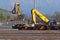 Large excavators with  grapples while  they grabbing industrial ferrous material scrap