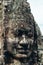 Large face-shaped statue in the ruins of the Bayon temple in Ankgor Thom, Cambodia - Unesco World Heritage Site 1992