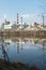 A large factory is located on the river bank. Toxic white smoke escapes from the factory\\\'s chimneys.