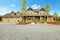 Large farm country house with gravel driveway and green landscape.