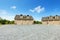 Large farm country house with gravel driveway and green landscape.