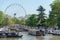 Large ferris wheel and canal boats and barges on a summer day in UK