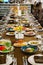 a large festive table with candles, snacks and tableware.