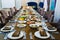 a large festive table with candles, snacks and tableware.