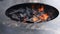 Large fire pit with charcoals close view