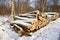 Large Firewood Stack in the forest covered with snow