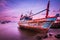 Large fishing boats beached at low tide.