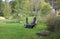 Large five tons ship anchor is mounted on green grass on a sunny spring day