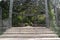 Large flagstone steps leading up to a metal gazebo with benches surrounded by trees and bushes in North Carolina