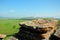 A large and flat sacrificial stone set on the top of a mountain overlooking the endless steppes