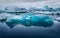 A large floating glacier on vary still water from Jokulsarlon, Iceland, wintertime.