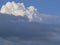 A large fluffy beautiful cumulonimbus cloud high on a sunny day. Beautiful huge soft clouds form in the blue sky